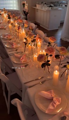 a long table is set with candles and plates