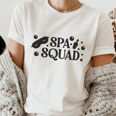 a woman wearing a white shirt with the words spa squad printed on it