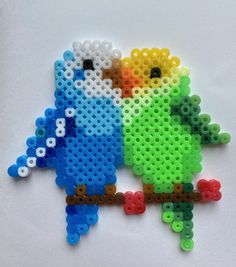 two colorful birds made out of perler beads