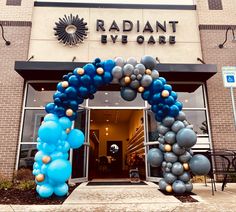 the entrance to radiant live care is decorated with blue, silver and gold balloons