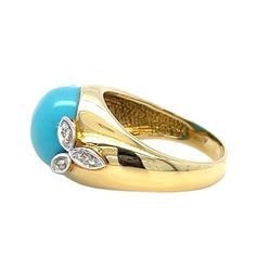 a yellow gold ring with blue and white stones