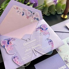 a purple and pink butterfly themed wedding suite with matching envelopes, cards and flowers