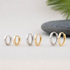 Our minimalistic huggie hoop earrings are sold as 1 pair, 2 pairs, or 3 pairs sets! They are perfect for everyday wear and even sleep in them. Made of sterling silver, or 18 K gold filled, hypoallergenic, tarnish free and waterproof ! - Qty: Sold in PAIRS - Size: INNER Diameter: 8mm, 10mm, 12mm  - Material: Hypoallergenic, high quality 925 sterling silver, 14K Gold filled (Core sterling silver) - Turnaround time: Same day or Next day delivery guaranteed  - Individually inspected and packed in a gift jewelry box with care  - Please ask me any questions ! I am quick to reply :) Thank you for visiting my shop  - For shop policies, please visit: https://www.etsy.com/shop/DoodleJewelrybyDKArt Hypoallergenic Huggie Cartilage Earrings, Stackable Sterling Silver Huggie Earrings As Gift, Sterling Silver Stackable Huggie Earrings As Gift, Hypoallergenic Huggie Cartilage Earrings As Gift, Minimalist Stackable Huggie Earrings For Gift, Minimalist Stackable Huggie Earrings As Gift, Stackable Huggie Earrings For Gift, Minimalist Stackable Huggie Cartilage Earrings, Silver Stackable Huggie Earrings