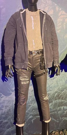 a mannequin is dressed in leather pants and jacket with holes on the sides