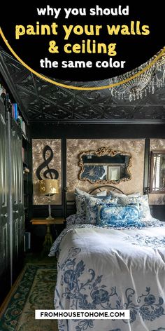 a bed with blue and white comforter next to a mirror on the wall above it