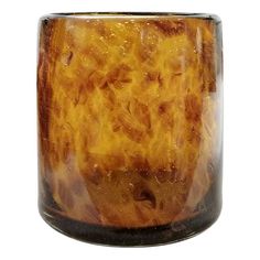 a close up of a glass vase with yellow and brown swirls on the inside