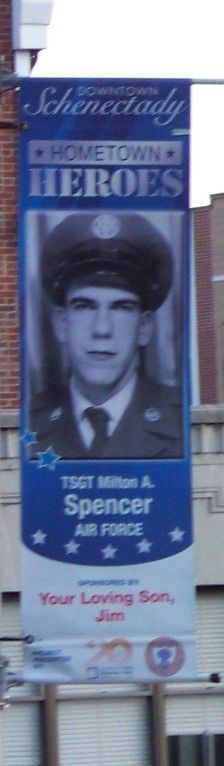 a billboard on the side of a building with a man in uniform wearing a hat