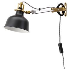 a black and gold desk lamp on a white background with a cord attached to it