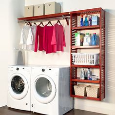 a washer and dryer sitting next to each other in front of a shelf