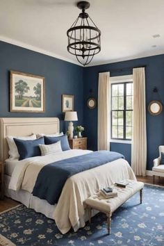 a bedroom with blue walls, white bedding and an area rug on the floor