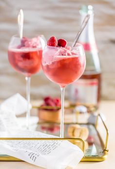 two wine glasses filled with raspberry champagne