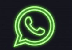 the whatsapp logo is glowing green on a black background