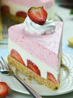 a slice of strawberry cheesecake on a plate with a fork next to it and another piece in the background