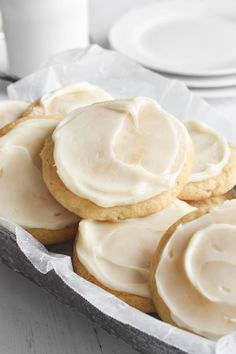 buttermilk cookies in a tin with frosting on top