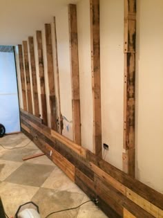 a room that is being remodeled with some wood on the floor and walls in it