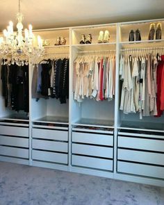 an organized closet with chandelier and shoes