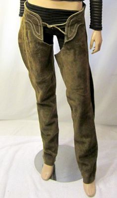 This is a wonderful pair of cowboy/cowgirl brown suede Western chaps.  Each leg has a side zipper for accessibility and the chaps have a belted buckle in the front which is adjustable.  The back is also belted and adjustable with the use of leather strings which must be interwoven through the holes in the belt to get the proper fit. The chaps are in excellent vintage condition, would be suitable for a Small to Medium sized figure type or frame and are ready-to-wear to your next rodeo. Please not Western Chaps, Crochet Lace Shorts, Adventure Outfit, Womens Trousers, Cowboy Cowgirl, Cowboy And Cowgirl, Ruby Lane, Brown Suede, Western Wear