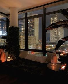 a bedroom with a view of the city at night