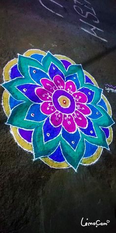 a colorful flower is drawn on the ground