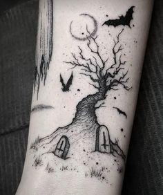 a black and white photo of a tree with bats on it's arm, in front of a full moon