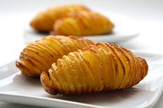 two pieces of potato sitting on top of a white plate