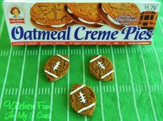 three cookies with footballs on them sitting next to a box of oatmeal creme pies