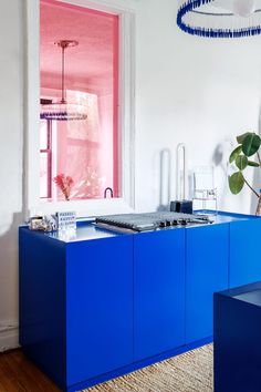 a kitchen with blue cabinets and white walls