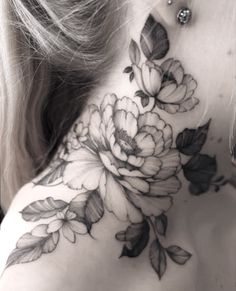 a woman's neck with flowers on it