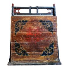 an old wooden box with painted designs on it's sides and bottom, isolated against a white background