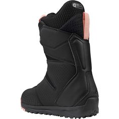 a black snowboard boot with pink linings on the side and bottom part of the boot