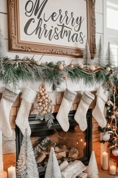 a fireplace decorated for christmas with stockings and pine cones