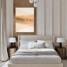 a white bed sitting in a bedroom next to two lamps on either side of the bed