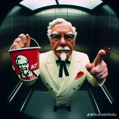 an older man in a suit and tie holding a bucket with kfc logo on it