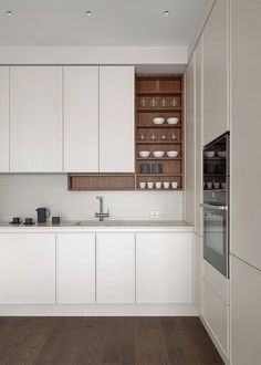 the kitchen is clean and ready for us to use it's white cabinetry