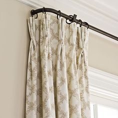 the curtains are hanging on the rod in front of the window, and there is no curtain