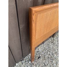 a close up of a wooden headboard on gravel