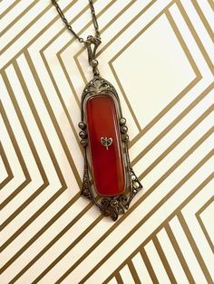 "This lovely Carnelian and Marcasite pendant and chain are German-made and is certainly representative of the Art Deco period, along with the workmanship for which German artists are known.   Stamp:  GERMANY STERLING (unknown trademark) Measurements: Pendant:  2-1/4\" long x 15/16\" wide Chain: 23\" long Total weight:  9.3 grams Closure:  spring ring in good working order Very Good Condition - all stones in place" Antique Orange Gemstone Jewelry, Elegant Carnelian Necklace With Large Pendant, Formal Orange Carnelian Necklace, Antique Red Necklace With Large Pendant, Elegant Carnelian Jewelry With Large Pendant, Antique Amber Necklace With Gemstone, Formal Carnelian Pendant Necklace, Antique Amber Gemstone Necklace, Carnelian Pendant Necklace For Formal Events