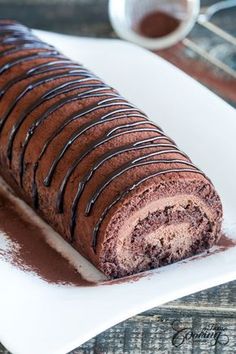 a piece of chocolate cake sitting on top of a white plate