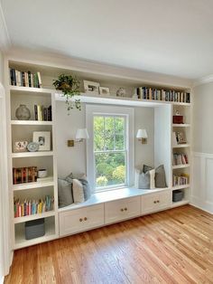 a room with some bookshelves and a window in the wall next to it