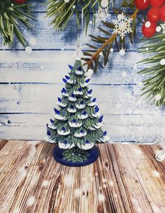 a small christmas tree sitting on top of a wooden table