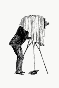 a man standing next to an old fashioned camera on a tripod looking into the ground