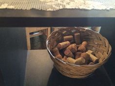 a basket filled with wine corks on top of a table