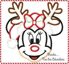 a mickey mouse face with reindeer antlers on it