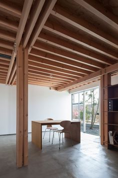 an empty room with a table and bookshelf