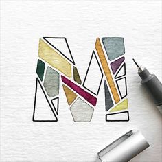 the letter m is made up of different colored shapes and lines, with a fountain pen next to it