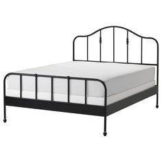 a black metal bed frame with white sheets