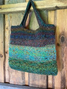 a multicolored bag hanging on a wooden wall