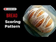 a loaf of bread sitting on top of a piece of paper with the words bread scoring pattern