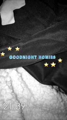 there is a black bag with gold stars on it and the words goodnight homes written in blue