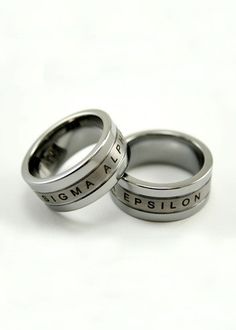 two wedding rings with the words birmingham and brighton engraved on them, sitting next to each other